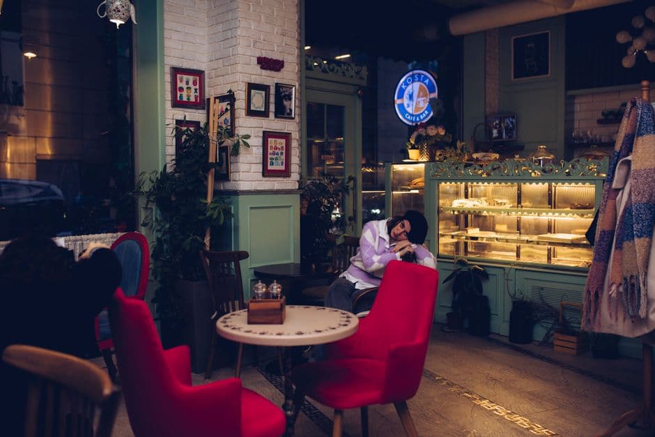 Warm and inviting cafe interior featuring people relaxing and enjoying cozy ambiance